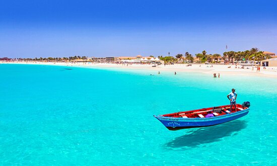 Traditional fishing boat on the turquoise water of Santa Maria beach, Sal, Cape Verde